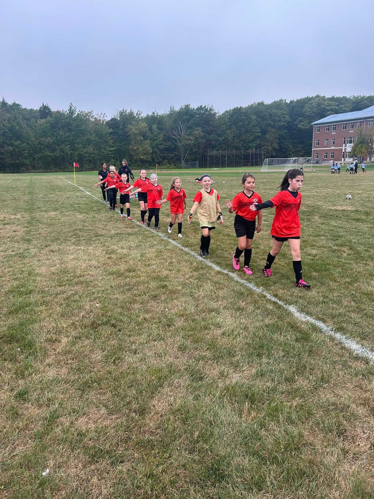 Youth soccer team running on field