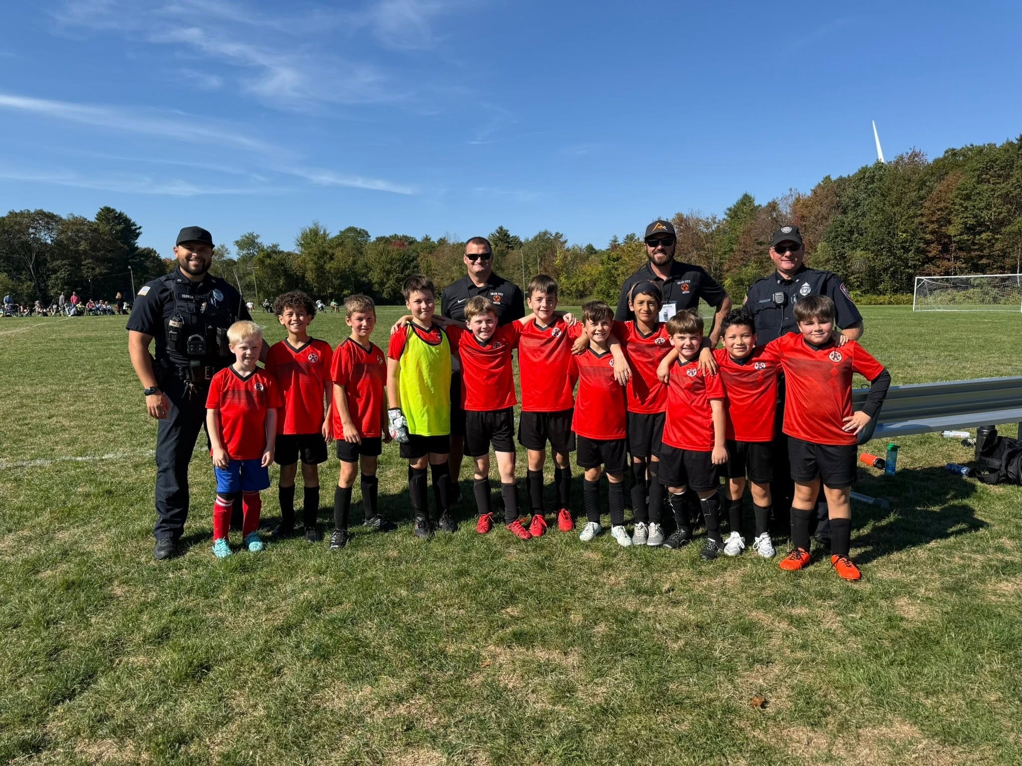 Youth soccer team with coaches on field